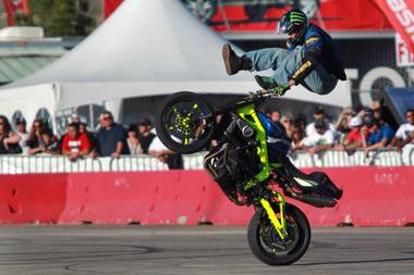 Freestyle motorcycle rider Nick Brocha performs in the parking lot of Sam Boyd Stadium during the Monster Energy Cup on Saturday, Oct. 20, 2012.